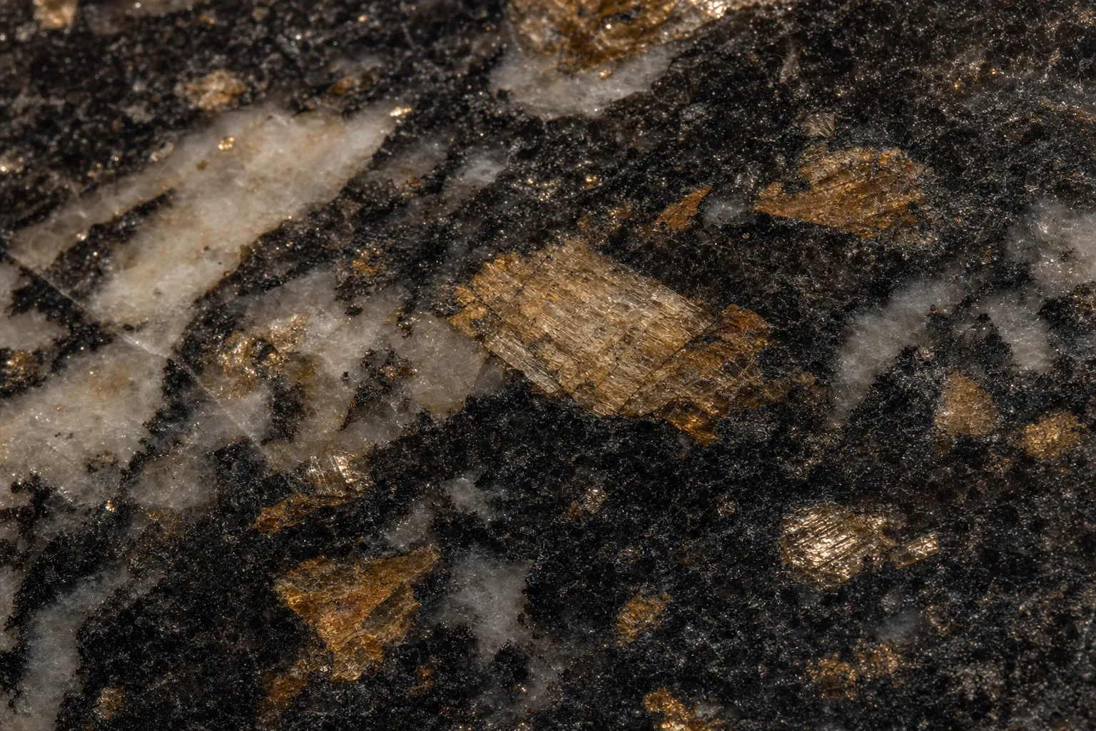 Close-up of granite countertop surface showing the natural mineral composition including quartz feldspar and mica crystals