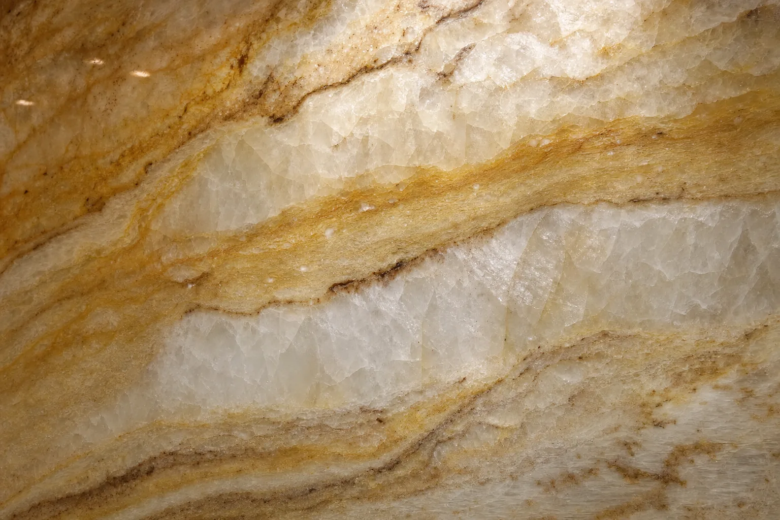 Dramatic Taj Mahal quartzite slab showing bold natural veining and warm golden tones